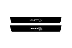 Catalog illustration of two black front door sill plates with SRT Hellcat lettering.
