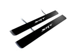 Two black door sill plates with white SRT lettering and visible wiring on a light background.