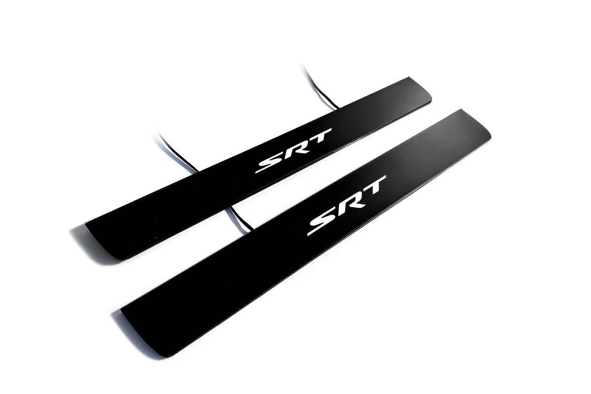 Two black door sill plates with white SRT lettering and visible wiring on a light background.