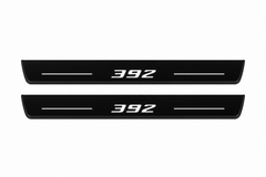 Catalogue illustration of two front black Matte PRO LED door sill plates with illuminated 392 lettering for Dodge Charger Sedan LD; the FRONT+REAR option includes rear plates not shown; final dimensions are selected during manufacture.