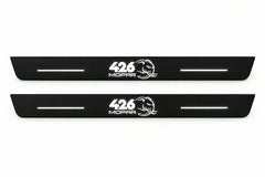 Catalogue illustration of two front black Matte PRO LED door sill plates with illuminated 426 Mopar Hellephant lettering for Dodge Charger Sedan LD; the FRONT+REAR option includes rear plates not shown; final dimensions are selected during manufacture.