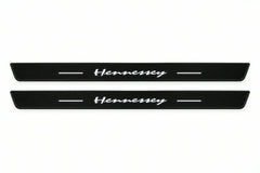 Catalogue illustration of two front black Matte PRO LED door sill plates with illuminated Hennessey lettering for Dodge Charger Sedan LD; the FRONT+REAR option includes rear plates not shown; final dimensions are selected during manufacture.