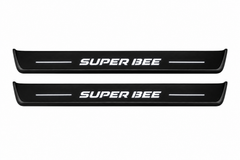 Catalogue illustration of two front black Matte PRO LED door sill plates with illuminated Super Bee lettering for Dodge Charger Sedan LD; the FRONT+REAR option includes rear plates not shown; final dimensions are selected during manufacture.