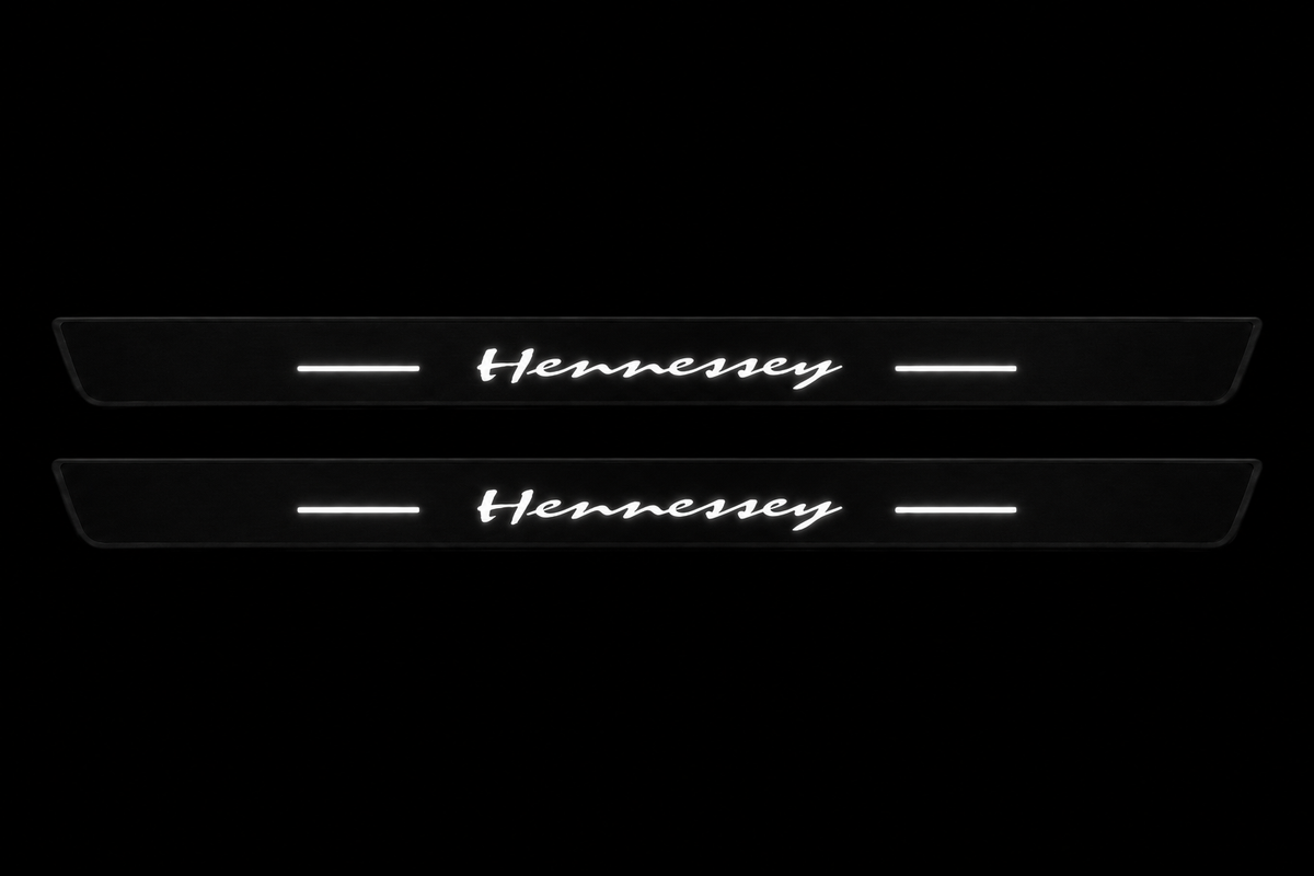 Two Hennessey Matte PRO front door sill plates; black body, continuous white artwork and four bars, unlit physical edges.