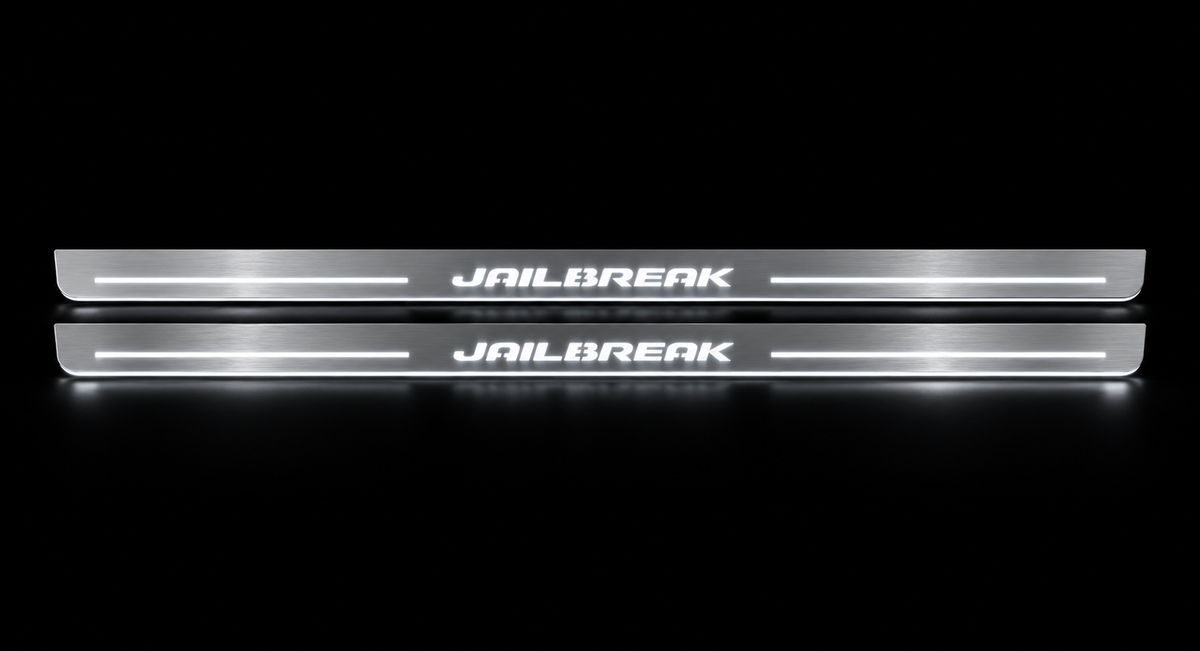 Slim stainless Jailbreak door sill pair with white LED, dark background.