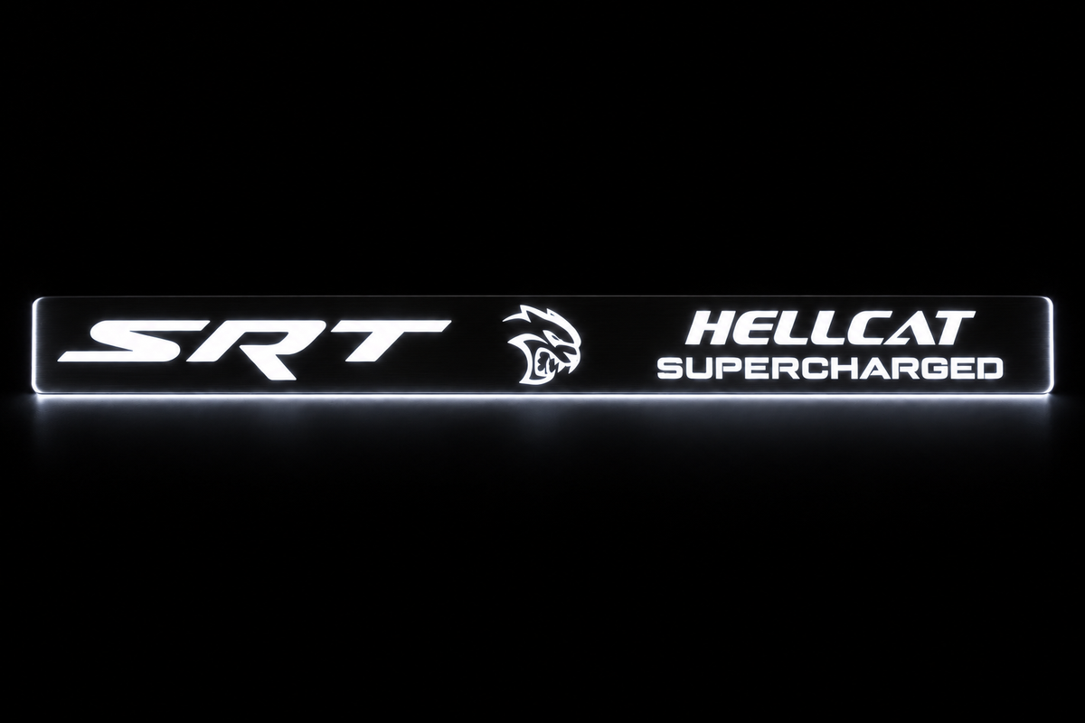 SRT Hellcat Supercharged door sill in darkness with white illuminated lettering, emblem and side edges.