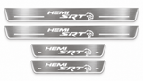 Four brushed stainless steel Dodge SRT HEMI Hellcat door sill plates with white LED graphics on a white background.