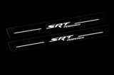 Night visualization of exact two-piece SRT POWERED Stainless front pair, white lettering and four bars on near-black bodies.