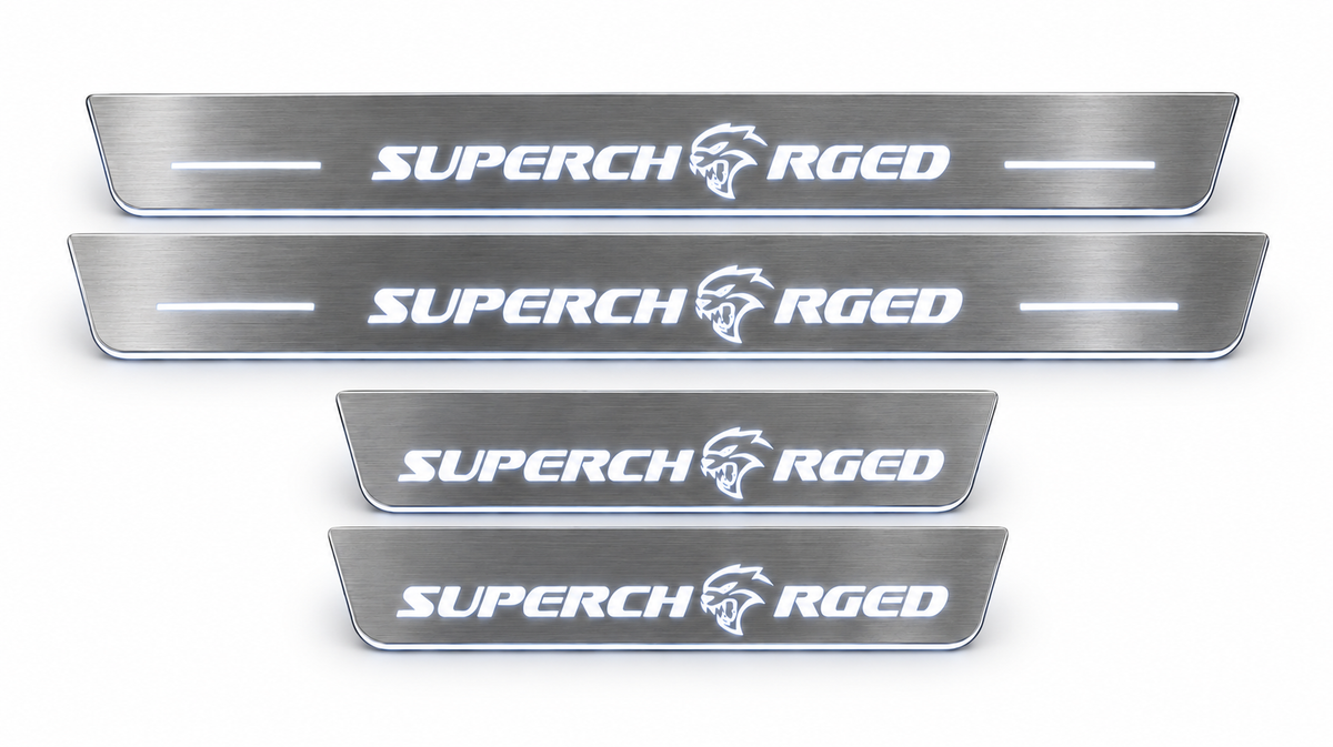Four brushed stainless Supercharged door sills with white LED illumination on white background.