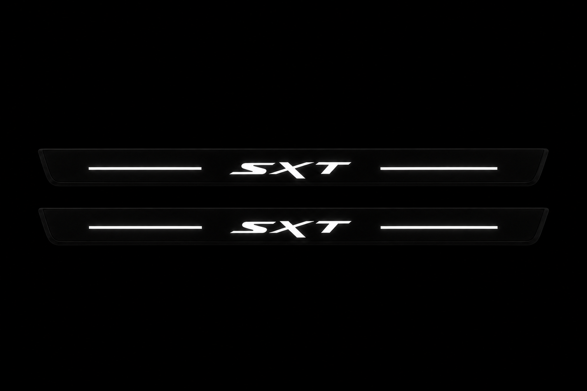Two exact SXT Matte PRO front door sill plates, black body with continuous white top-surface LED bars and lettering; physical edges unlit.