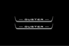Two long door sill plates with Duster lettering and edges illuminated in white, straight-on view on a dark background.