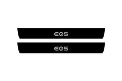 Catalog illustration of two black front door sill plates with EQS lettering.