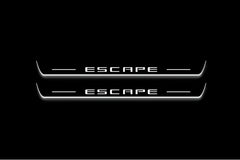 Two long door sill plates with Escape lettering and edges illuminated in white, straight-on view on a dark background.