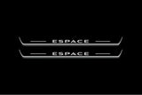 Two long door sill plates with Espace lettering and edges illuminated in white, straight-on view on a dark background.