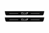 Catalogue illustration of two front black Matte PRO LED door sill plates with illuminated 500X lettering for Fiat 500X 334; the FRONT+REAR option includes rear plates not shown; final dimensions are selected during manufacture.