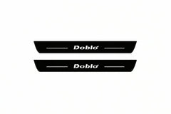 Catalogue illustration of two front black Matte PRO LED door sill plates with illuminated Doblo lettering for Fiat Doblo Van 223; dimensions are selected during manufacture.