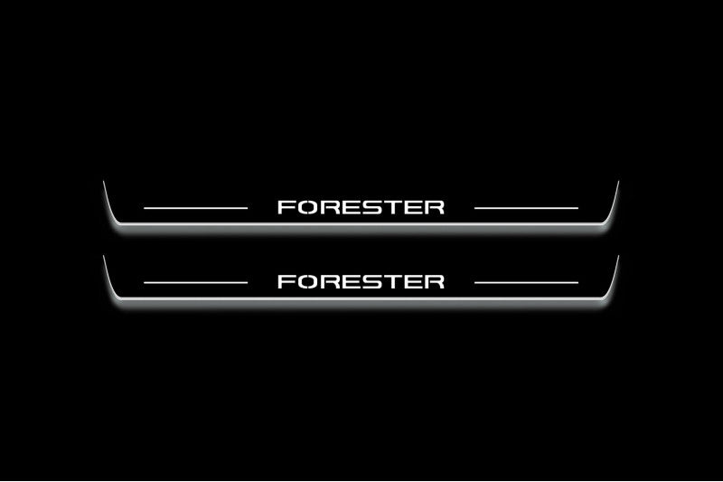 Two long door sill plates with Forester lettering and edges illuminated in white, straight-on view on a dark background.