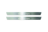 Two long silver-finished door sill plates with Forester lettering on a light background, straight-on view.
