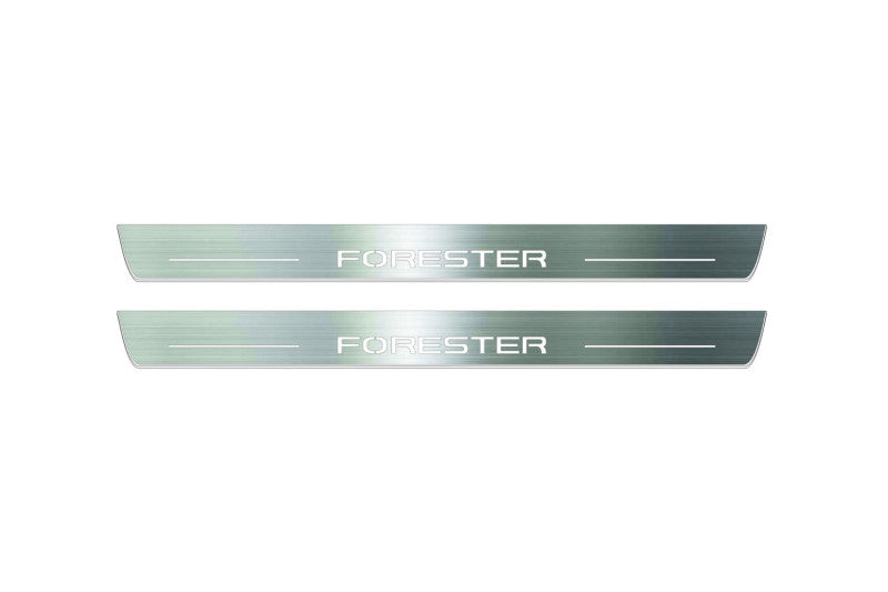 Two long silver-finished door sill plates with Forester lettering on a light background, straight-on view.