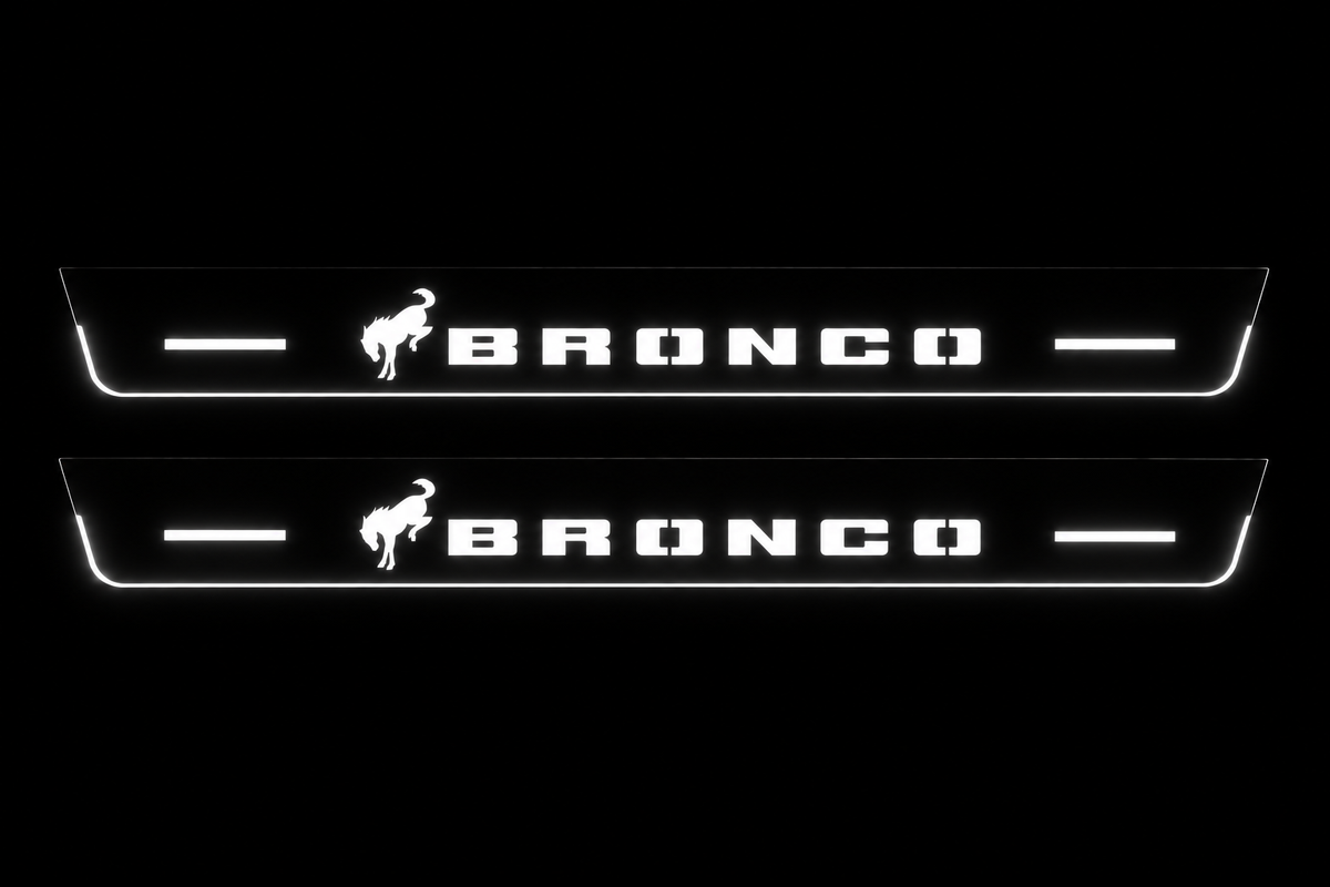 Product visualization: two flat Bronco front plates, one horse and bars on each. Black night background, unlit stainless face nearly hidden, white illuminated artwork, bars and real side/end edges with soft glow.