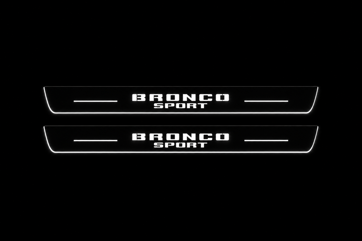 Product visualization: two exact Bronco Sport front plates, stacked original words, no horse flat brushed stainless steel door sill plates with white LED artwork and edges, dark background.