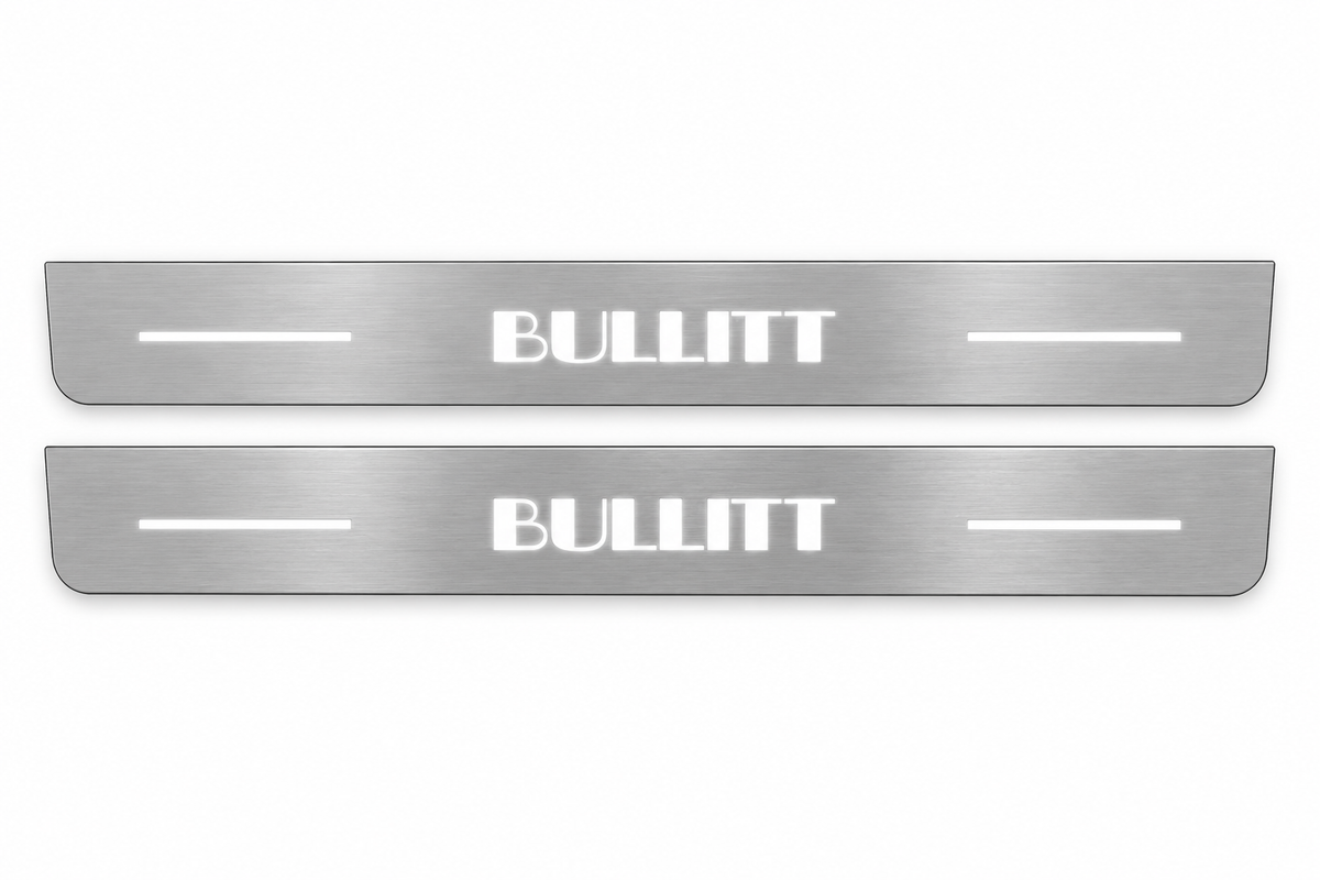 Product visualization: two flat original bullitt-s197-bars Stainless front plates with exact artwork and white lower/end LEDs flat brushed stainless steel door sill plates with white LED artwork and edges, white background.