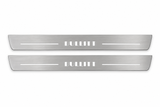 Product visualization: two flat original bullitt-s197-stencil Stainless front plates with exact artwork and white lower/end LEDs flat brushed stainless steel door sill plates with white LED artwork and edges, white background.