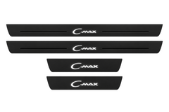 Catalog illustration of two front and two rear black Matte PRO door sill plates with stylized C-Max lettering and flanking lines illuminated on top; opaque unlit side edges. Final dimensions selected for Ford C-Max I C214 during manufacture.