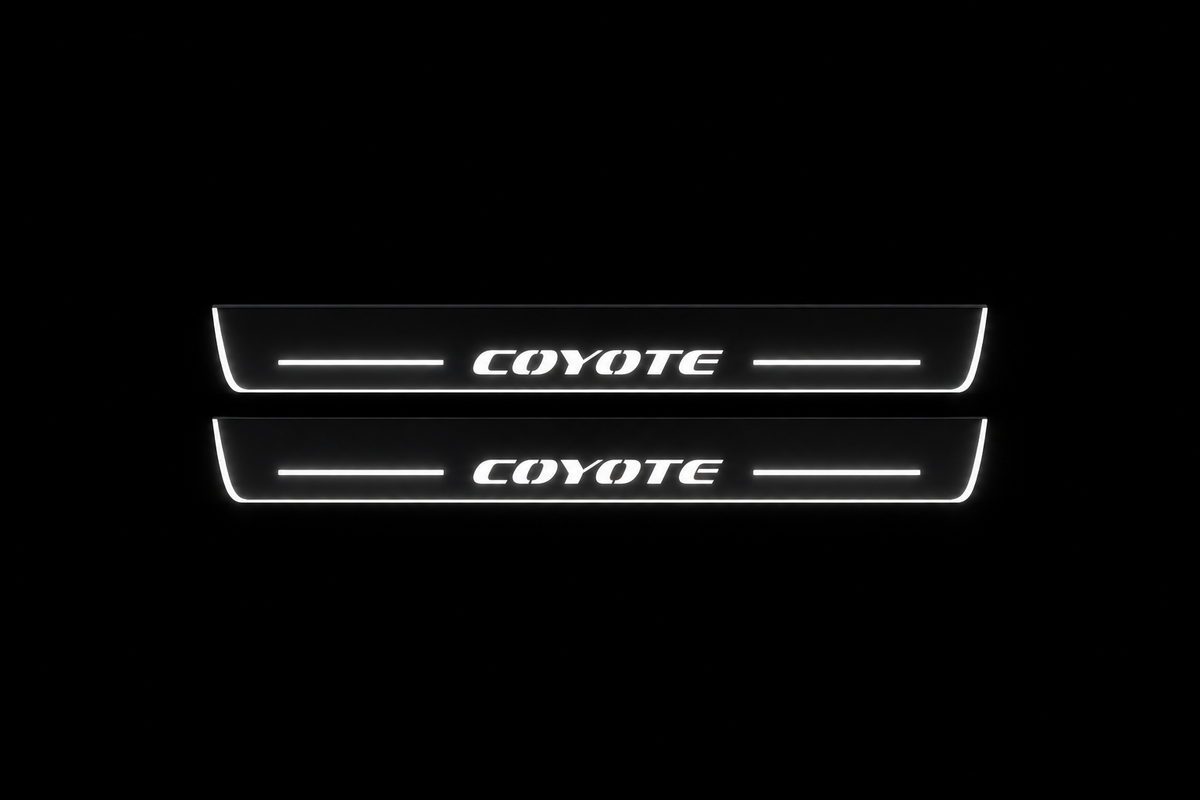 Product visualization: two flat original coyote-s197 Stainless front plates with exact artwork and white lower/end LEDs flat brushed stainless steel door sill plates with white LED artwork and edges, dark background.