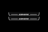 Product visualization: two flat original coyote-s197 Stainless front plates with exact artwork and white lower/end LEDs flat brushed stainless steel door sill plates with white LED artwork and edges, dark background.