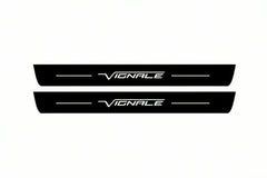 Shared catalogue illustration of two black Matte PRO front plates with illuminated Vignale script and unlit edges. FRONT+REAR also includes two rear plates not shown; Ford Edge CD539 dimensions are determined during manufacture.