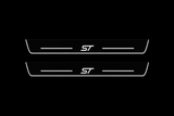 Product visualization: two flat Ford Edge ST front plates with exact ST logo and bars. Black night background, unlit stainless face nearly hidden, white illuminated artwork, bars and real side/end edges with soft glow.