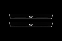 Product visualization: two flat Ford Edge ST front plates with exact ST logo and bars. Black night background, unlit stainless face nearly hidden, white illuminated artwork, bars and real side/end edges with soft glow.