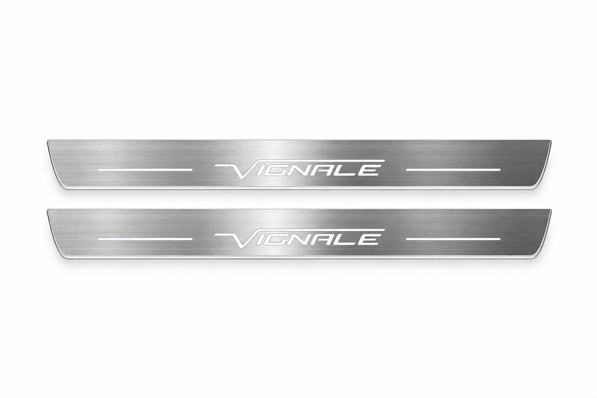 Product visualization: two exact slender Edge Vignale front plates with own logo overline and bars flat brushed stainless steel door sill plates with white LED artwork and edges, white background.