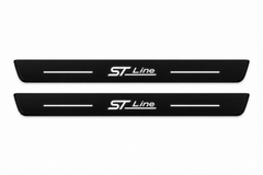 Catalogue illustration of two front black Matte PRO plates with illuminated ST Line lettering and horizontal top lines. Side edges are unlit; FRONT+REAR includes two rear plates not shown. Dimensions are selected for the Ford Escape CX482 during manufacture.