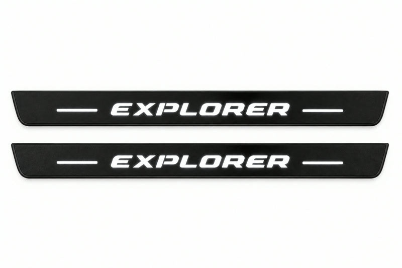 Shared catalogue illustration of two black Matte PRO front plates with italic illuminated Explorer lettering and unlit edges. The FRONT+REAR set also includes two rear plates not shown; final dimensions are selected for Ford Explorer CD6 during manufacture.