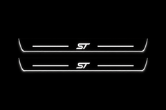 Product visualization: two flat Ford Focus ST front plates with exact ST logo and bars. Black night background, unlit stainless face nearly hidden, white illuminated artwork, bars and real side/end edges with soft glow.