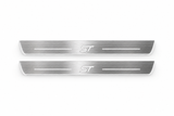 Product visualization: two Ford Focus ST FRONT flat brushed stainless steel door sill plates with white LED artwork and edges, white background.