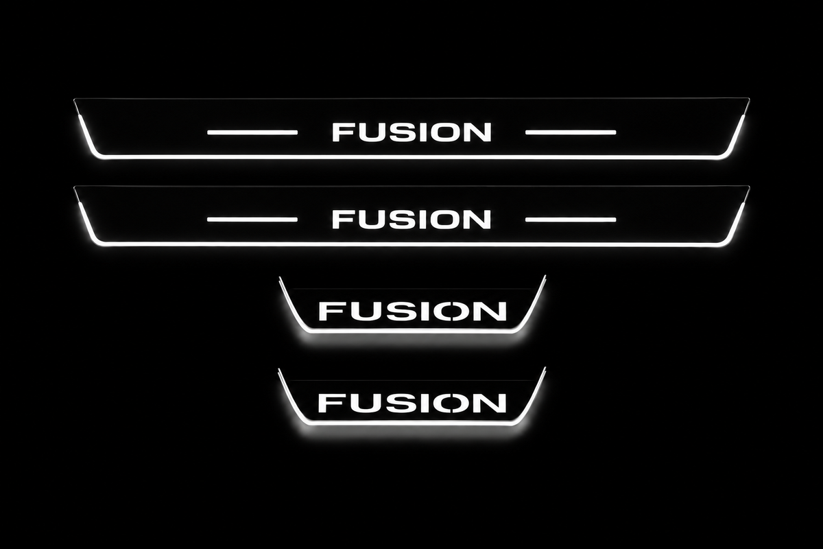 Product visualization: four flat Stainless Steel door-sill plates, two long front and two shorter rear plates. Original artwork and actual edge/end LED zones illuminated white on black; not an installation photograph.