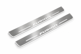 Product visualization: FUSION exact stencil, two flat source front plates flat brushed stainless steel door sill plates with white LED artwork and edges, white background.