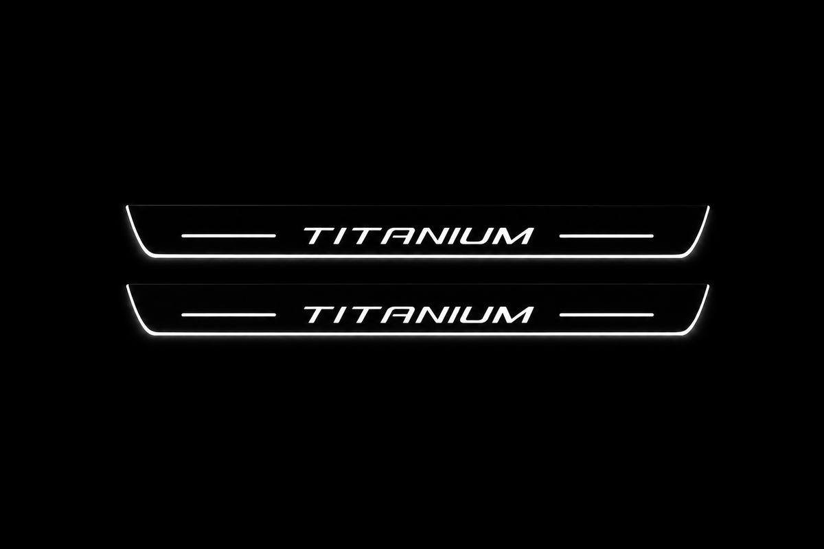 Product visualization: two exact Kuga Titanium front plates, own slender contour and artwork flat brushed stainless steel door sill plates with white LED artwork and edges, dark background.