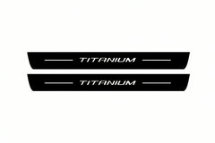 Catalogue illustration of two front black Matte PRO LED door sill plates with illuminated Titanium lettering for Ford Mondeo Estate CD391; dimensions are selected during manufacture.