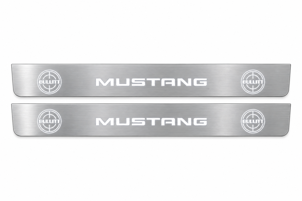 Product visualization: two flat mustang-bullitt-targets Stainless front plates with original source lettering and white LED zones flat brushed stainless steel door sill plates with white LED artwork and edges, white background.