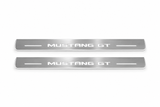 Product visualization: mustang-gt-s197 exact MUSTANG GT source artwork, two flat front plates flat brushed stainless steel door sill plates with white LED artwork and edges, white background.