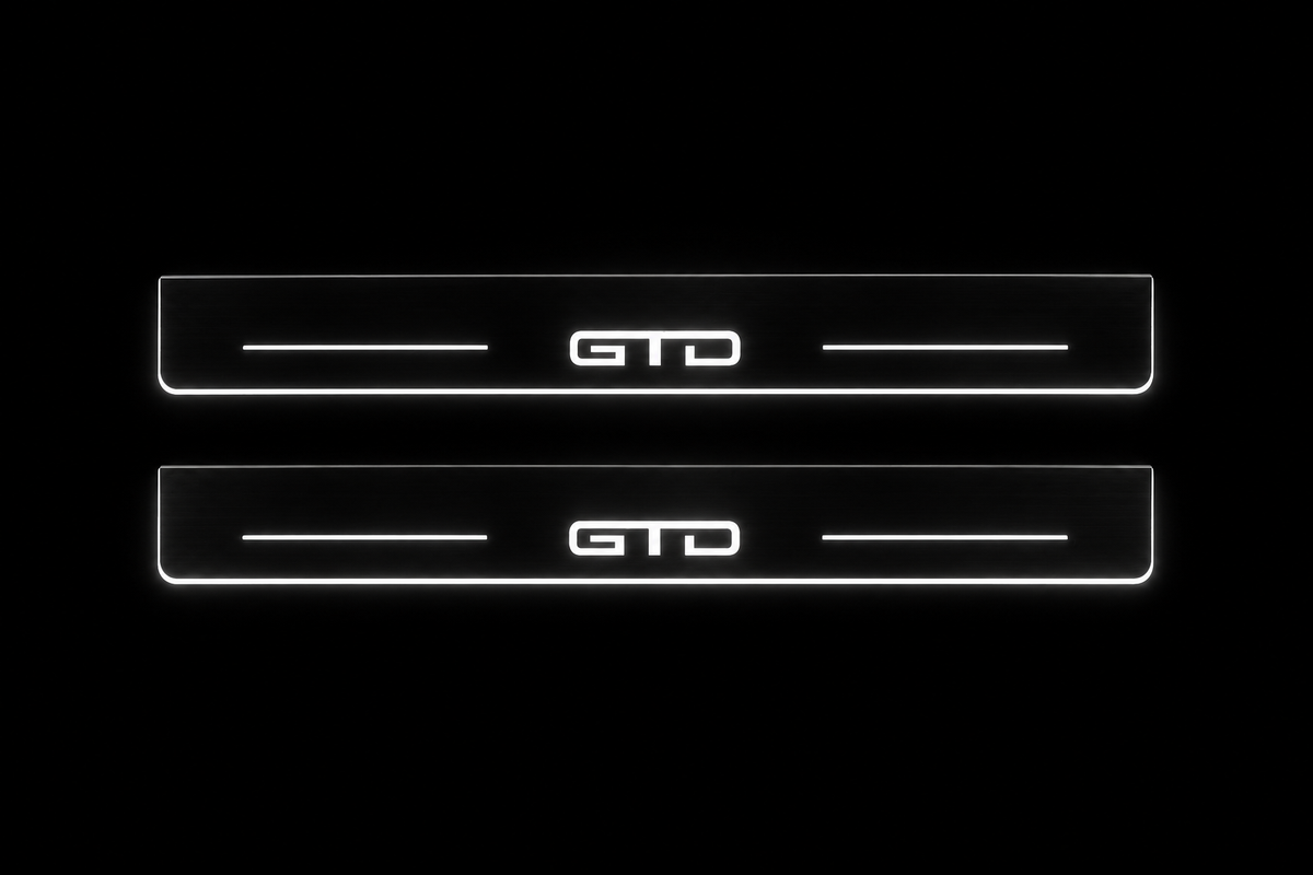 Product visualization: GTD exact source artwork, two broad flat front plates; accepted v3 proportions flat brushed stainless steel door sill plates with white LED artwork and edges, dark background.