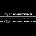 Product visualization: two exact mustang-pony-legacy flat Stainless front sill plates with original artwork, neutral white LEDs and own thin-edge geometry flat brushed stainless steel door sill plates with white LED artwork and edges, dark background.