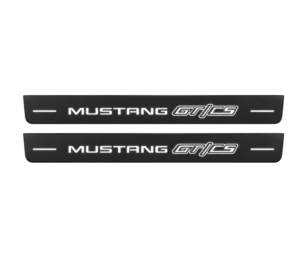 Matte PRO catalogue illustration showing two FRONT plates with illuminated Mustang GT/CS lettering on a white background; Ford Mustang V S197 dimensions are selected during manufacture; rear plates are not pictured.