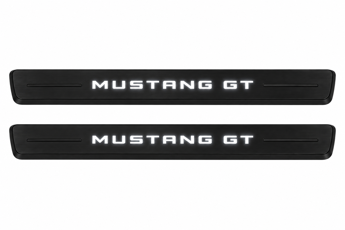 Catalogue illustration of two black Matte PRO front sill plates with illuminated MUSTANG GT lettering on top. Decorative bars and edges remain unlit; no rear plates or exact dimensions pictured.