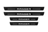 Catalog illustration of two front and two rear black Matte PRO door sill plates with RANGER lettering and horizontal lines illuminated on top; opaque unlit side edges. Final dimensions selected for Ford Ranger T6 during manufacture.