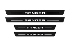 Catalog illustration of two front and two rear black Matte PRO door sill plates with RANGER lettering and horizontal lines illuminated on top; opaque unlit side edges. Final dimensions selected for Ford Ranger T6 during manufacture.